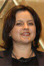 Profile image of Nora Sandoval, Director of Master's Student Affairs. Nora has shoulder-length dark hair and is smiling. 